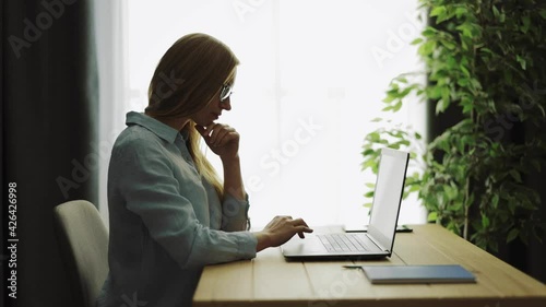 Woman browsing internet on laptop photo
