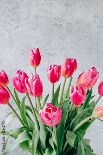 Fresh tulip flowers on a white wooden background. Bright spring background.