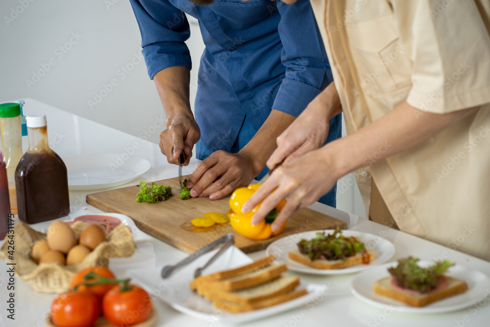 Asian young men lover LGBTQ cooking in the kitchen work from home 