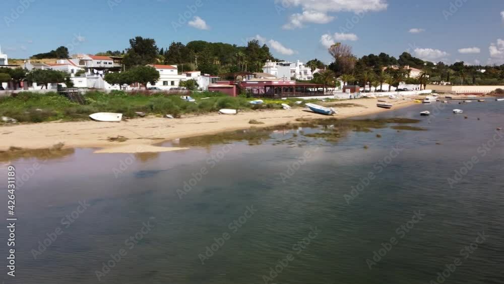 Aerial Pan Of A  Beautiful  Little Village Just Over A Beautiful Lagoon in Algarve Portugal. 4K for Youtubers