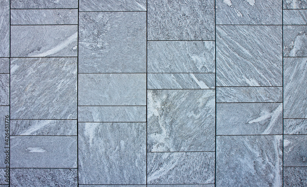New grey paving made with stone blocks of rectangular shape in a pedestrian zone New grey paving made with stone blocks of rectangular shape in a pedestrian zone