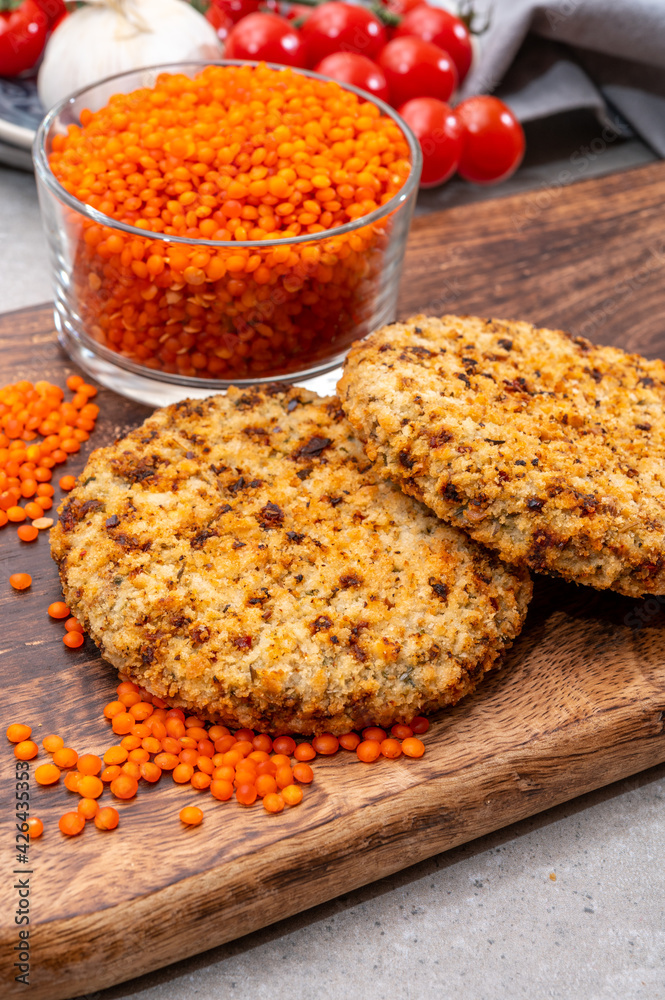 Healthy vegetarian or vegan food, meat free burger made from orange lentils legumes Healthy vegetarian or vegan food, meat free burger made from orange lentils legumes