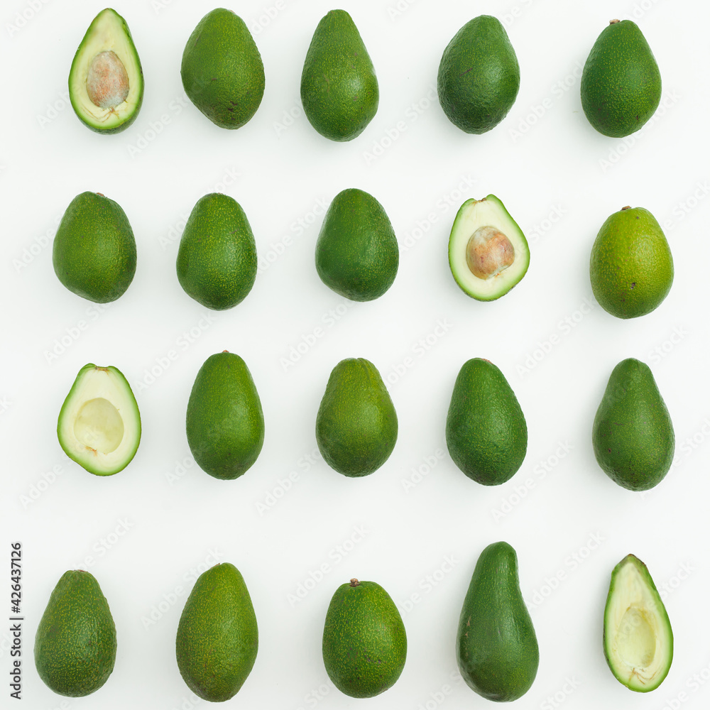 Avocado whole and half on white background. Flat lay, top view Avocado whole and half on white background. Flat lay, top view