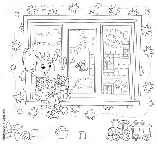 Little boy playing with his cute small kitten on a windowsill in a nursery room with starry wallpaper and funny toys on a sunny summer day, black and white vector cartoon illustration
