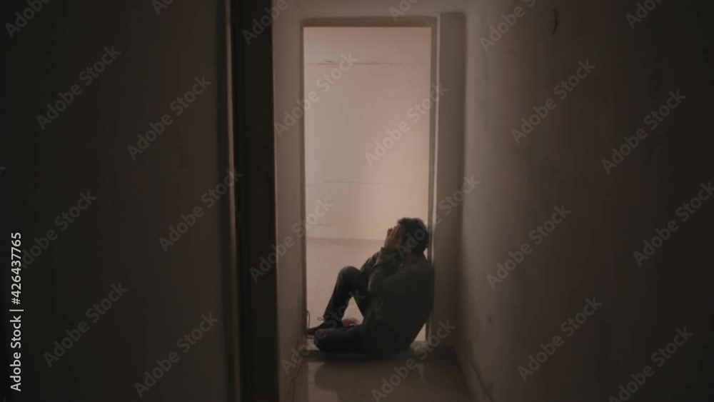 A sad man, sitting on the floor near a door in his house, painfully crying in desperation, alone.
A sad man, sitting on the floor near a door in his house, painfully crying in desperation, alone.