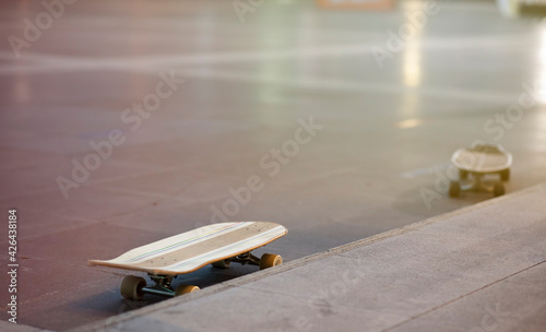  Surf skate board on Outdoor sports field with orange light reflection on floor
