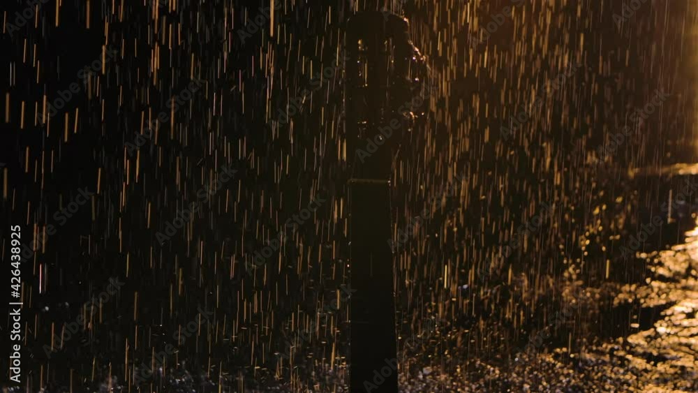 Detailed footage of a wooden acoustic guitar in the rain. Drops of ...