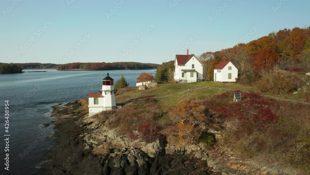 Orbiting Aerial shot of Squirrel point Lighthouse on Scenic Maine Coast