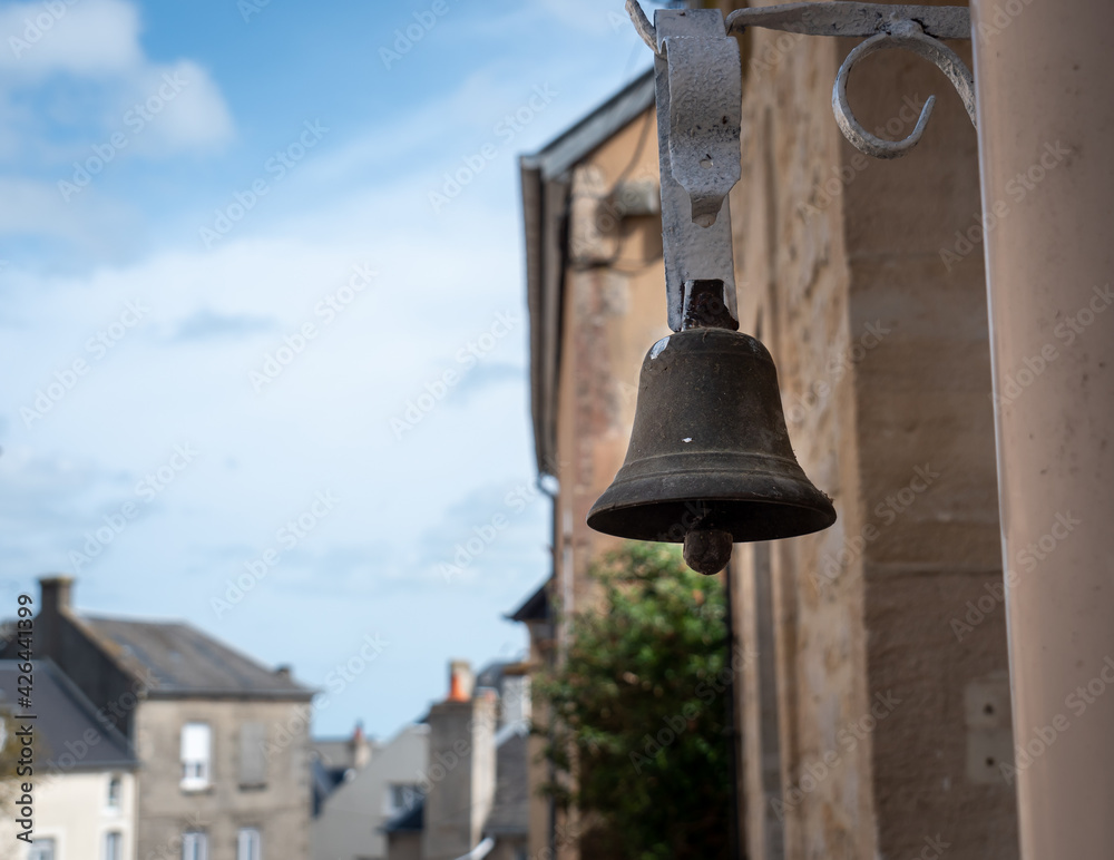 Obraz premium Port-en-Bessin-Huppain, France, March 2021. Old ringtone, bell before entering the house, photo close up