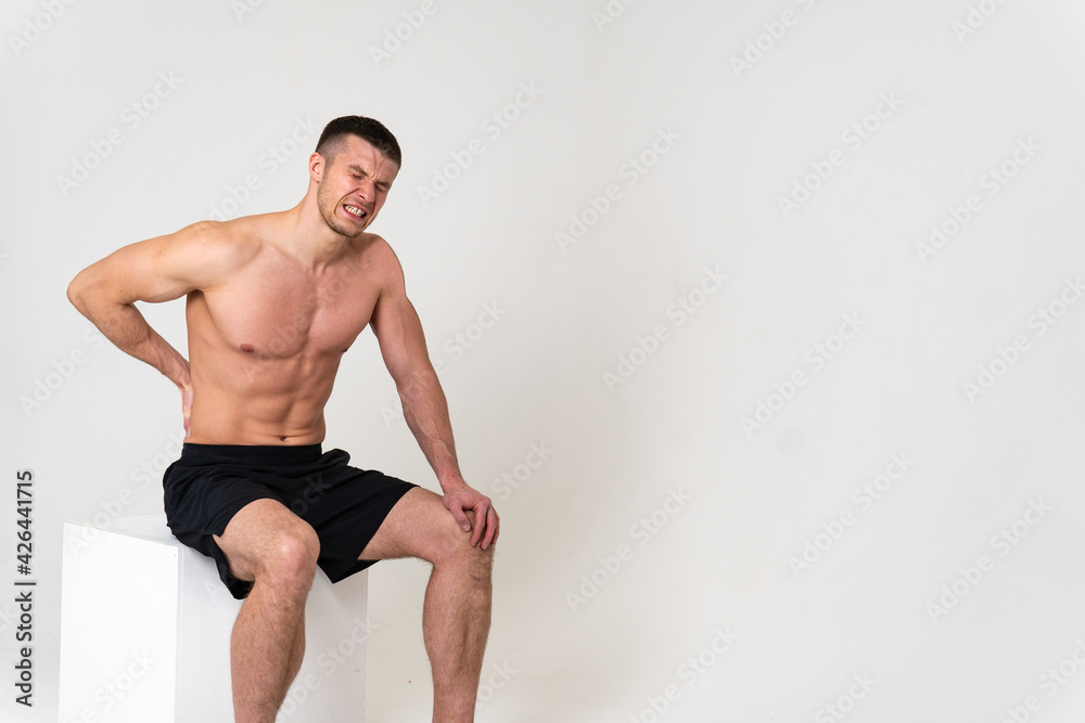 Obraz premium A man back pain keeps his hand on his back sore muscle, ill isolated background stress, human holding. Touching lumbar sickness, problem suffer attractive