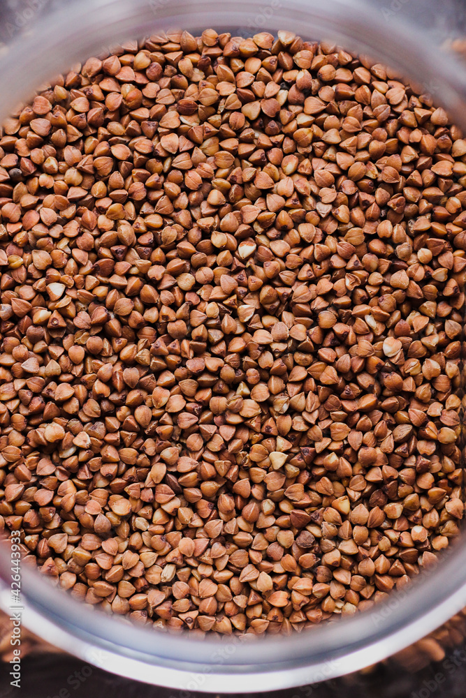 Hulled common buckwheat grains, surface and background. Dried seeds. Food photo, close up from above. Hulled common buckwheat grains, surface and background. Dried seeds. Food photo, close up from above.