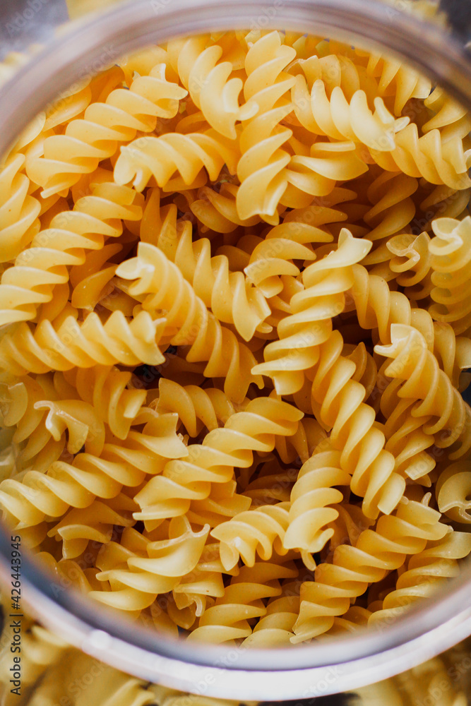 Pasta in glass jar on he black background Pasta in glass jar on he black background