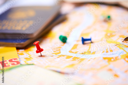 pins marking travel itinerary points on map and passport