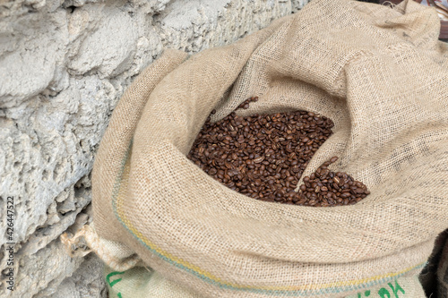 Top view of big jute sack with coffee beans on outdoor street food market, prepared for purchasing. Selling concept