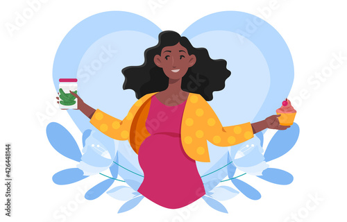 Smiling pregnant woman is craving cupcake and pickles