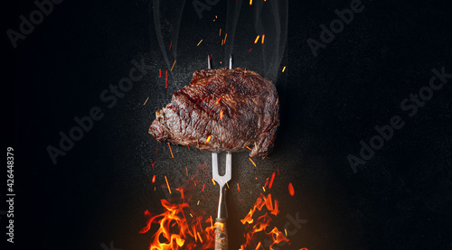 Leinwand Poster grilled beef steak on a dark background