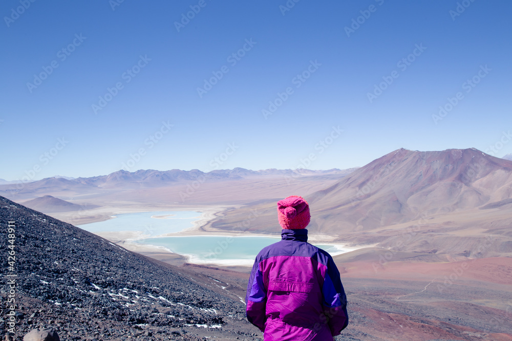 Fototapeta premium person contemplating infinity from a mountain 