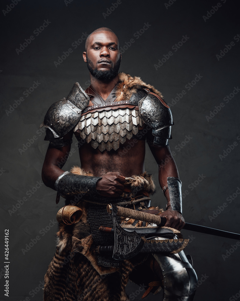 Powerful and handsome authentic soldier wearing armor with axe Powerful and handsome authentic soldier wearing armor with axe