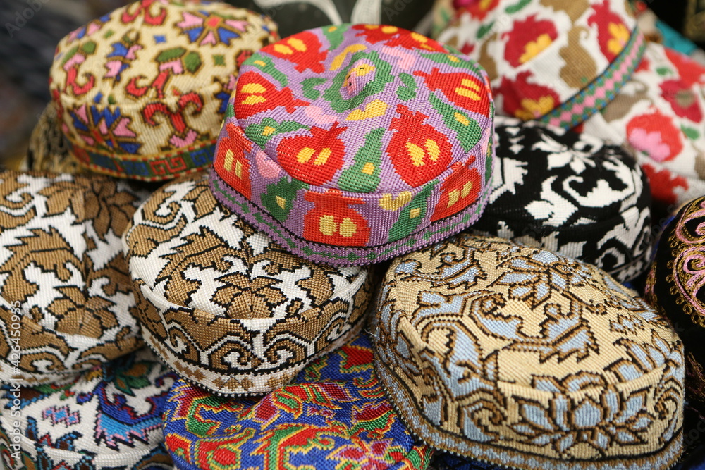 Skullcap, "tubereika". A lot of knitted ethnic hats: skullcaps on counter  of shop, store in Uzbekistan. Traditional national Uzbek headdress,  costume, dress, handicraft. Uzbek fashion style. Tubeteyka Stock Photo |  Adobe Stock