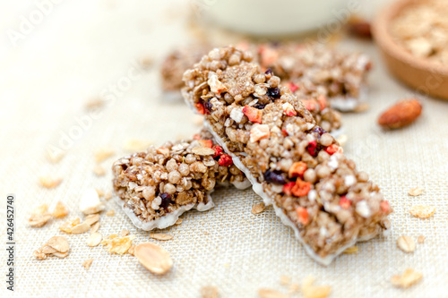 Granola Healthy Snack Bars Granola cereal bar with nuts and berries with yogurt on Sackcloth background