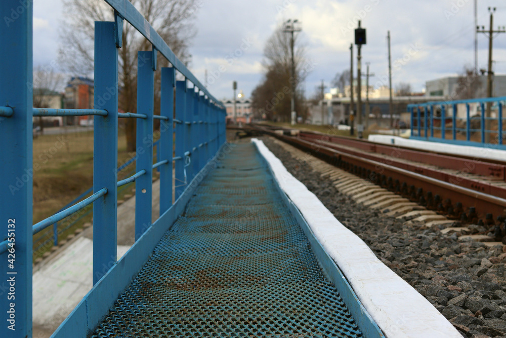 Blue transition bridge on rail tracks