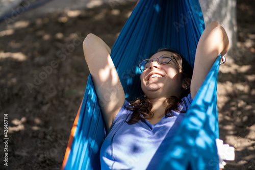 Beautiful pregnant girl smiling and being happy in a hammock