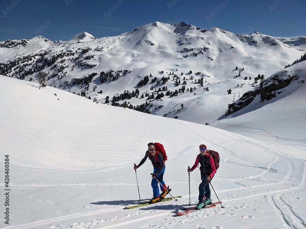 Ski mountaineering couple toward the mountain pass in a nice track with sealskin. Winter landscape in glarus. Snow Skimo