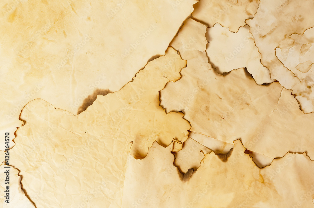 background made of pieces of old brown paper slightly burned on the edges background made of pieces of old brown paper slightly burned on the edges