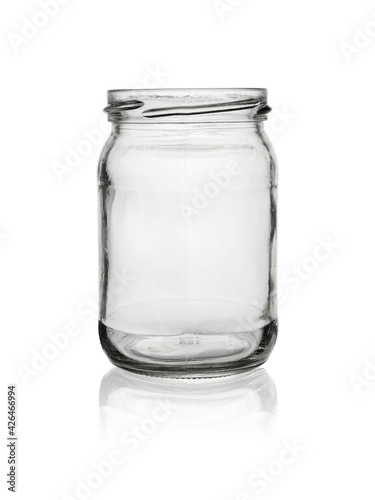 Empty, open jar of clear, colorless glass. Isolated on a white background with reflection.