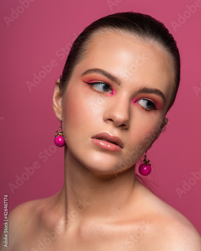 Hottest girl, round pink earrings and beautiful professional makeup