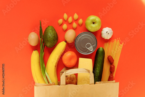 Various food set in the shopping bag on red background. Food delivery concept. photo