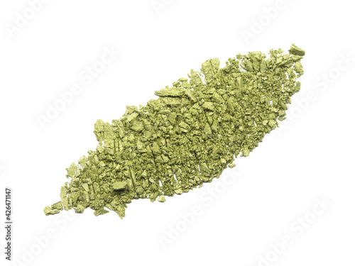Dry crushed green eyeshadow as sample of cosmetic product isolated on white