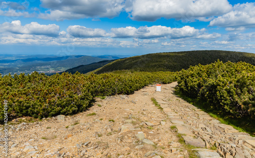 Long mountain trail with panorama if Karkonosze Giant Mountains around photo