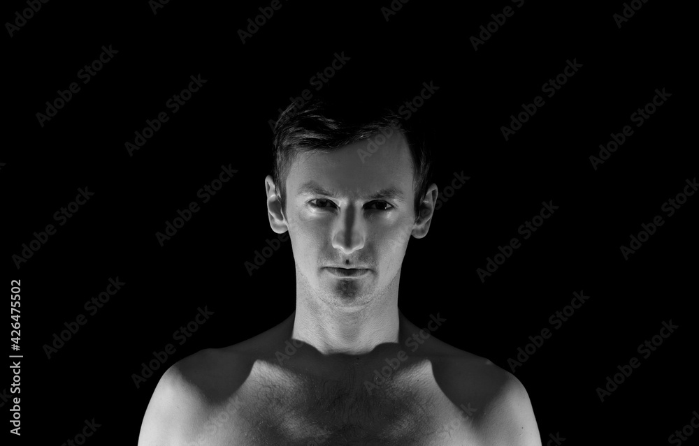 Fototapeta premium black and white photo portrait of a guy, in dramatic lighting