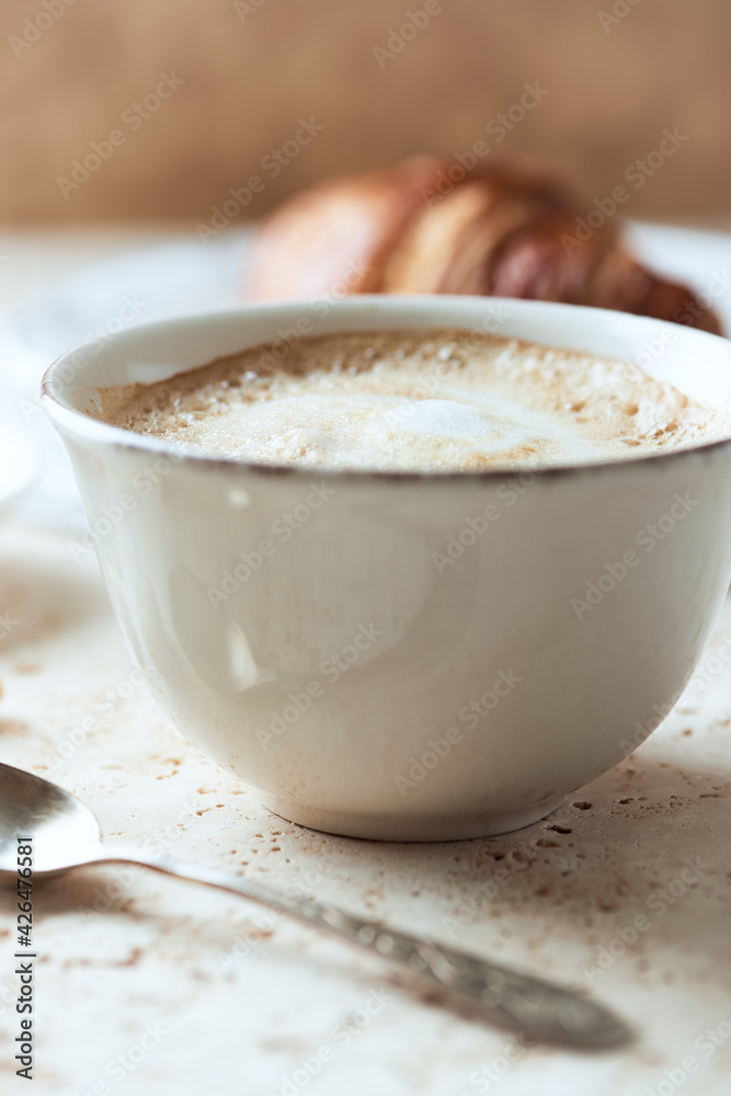 Coffee with milk on bright stone background. Close up. Coffee with milk on bright stone background. Close up.