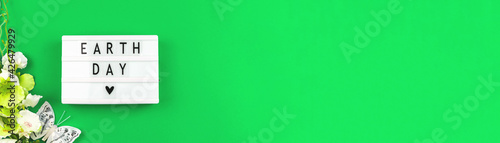 Earth Day celebration banner with green background, Environment Concept photo