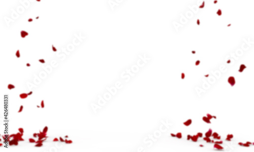 Red rose petals on a blurry background fly and fall to the floor. Blurred background