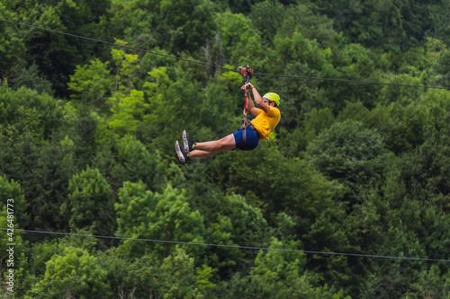 Zip line adventure, extreme rest, downhill on a rope at an angle
