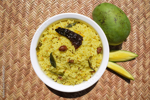 Ugadi festival food Mango rice also known as mamidikaya pulihora a traditional rice recipe prepared during telugu new year festive ugadi. served on wicker background photo