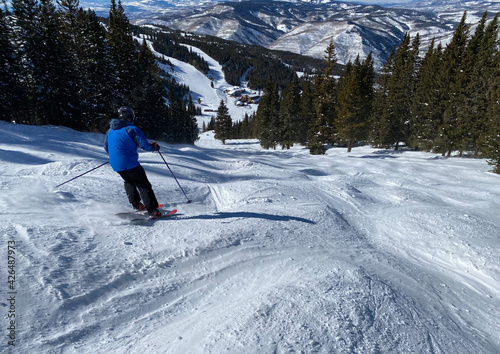 Skiing on sunny day at Vail Breckenridge ski resort in Colorado. photo