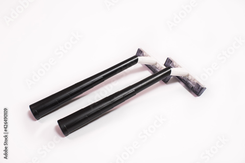 Two black disposable razors isolated on white background