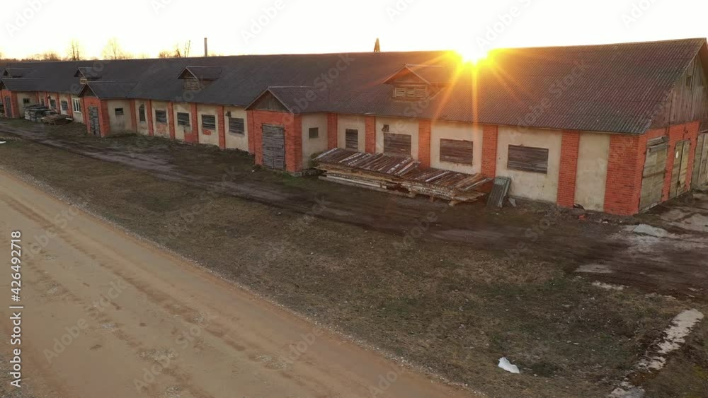 Abandoned Factory Building Exterior on Golden Hour Sunstar on Roof, Drone View Abandoned Factory Building Exterior on Golden Hour Sunstar on Roof, Drone View