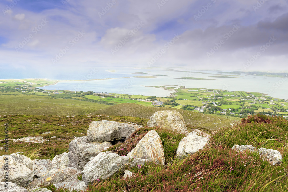 View on beautiful scenery. Croagh Patrick mountain view. Westport, county Mayo, Ireland. Irish nature landscape, Low cloudy sky. Nobody View on beautiful scenery. Croagh Patrick mountain view. Westport, county Mayo, Ireland. Irish nature landscape, Low cloudy sky. Nobody