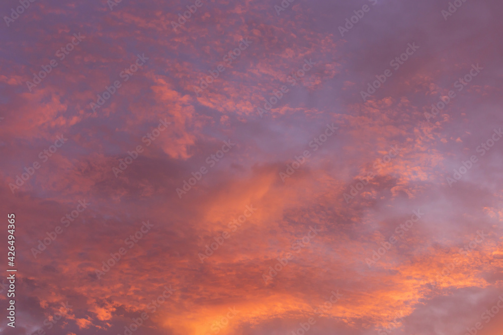 Epic dramatic sunrise, sunset pink violet orange blue sky with clouds background texture
