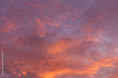 Epic dramatic sunrise, sunset pink violet orange blue sky with clouds background texture 