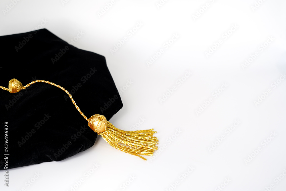 Isolated traditional black phd doctoral tam cap with gold tassel - obrazy, fototapety, plakaty 