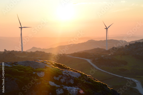 Wind Turbines and the sunset at the top of the mountain in Caramulo, Portugal photo