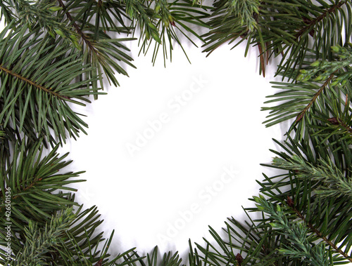 Natural frame of pine needles. In the middle is a white surface on which a message can be written. © Dragan