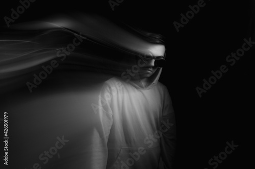 Facial face of a man in the dark. Art photography. Black-white art picture with a man. Portrait of man with blurred motion