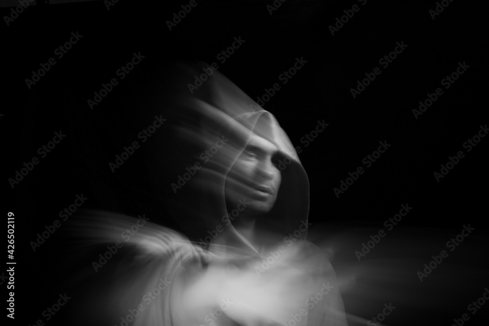 Facial face of a man in the dark. Art photography. Black-white art picture with a man. Portrait of man with blurred motion Facial face of a man in the dark. Art photography. Black-white art picture with a man. Portrait of man with blurred motion